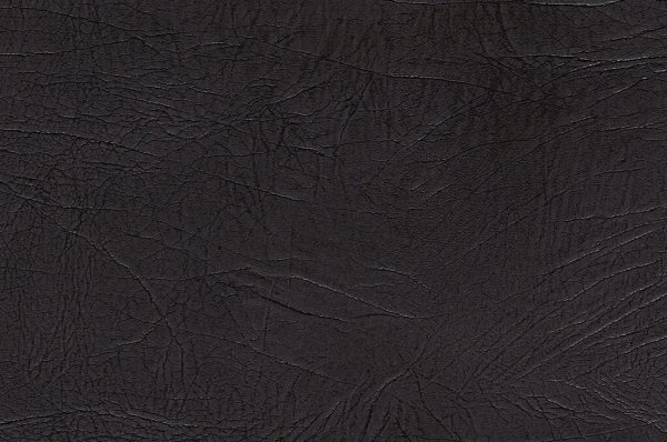 Close-up of Genova Black, featuring a dark brown, textured leather surface with visible natural wrinkles and creases.