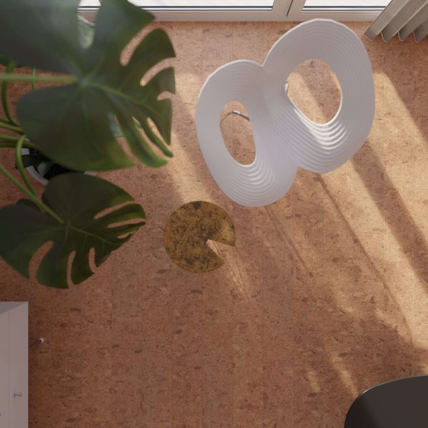 Top-down view of a modern room with a white sculptural chair, large green monstera plant, and round yellow rug on a Vintage Natural cork floor near a window.
