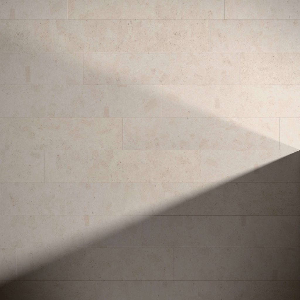 The Vintage Cinder tiles form a beige wall where a sharp shadow stretches diagonally from lower left to upper right, highlighting the contrast between light and dark across the surface.