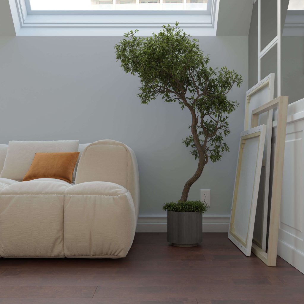 A cozy, modern living room features the Boulevard Jasper cream sofa with an orange cushion, a potted tree, two empty picture frames, and a skylight that fills the space with natural light.