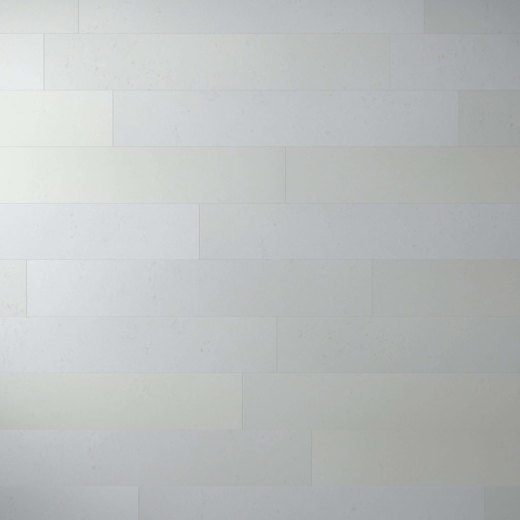 A wall covered with Burl African Ivory—large, horizontal, rectangular white tiles arranged in a staggered brick pattern. The surface is smooth and uniform with subtle shading variations.