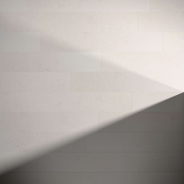 A diagonal shadow casts across Burl Linden, a neutral-toned tiled wall, creating a striking light and dark contrast from the top left to the bottom right.