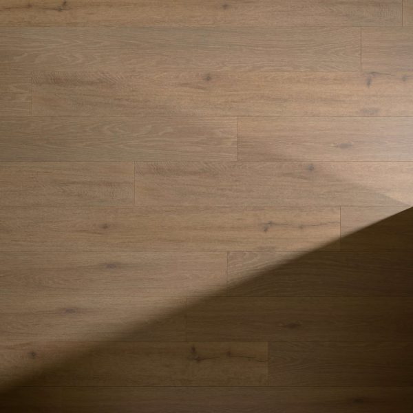 Creekbed Oak features light brown wooden floorboards with a distinct diagonal shadow, accentuating the natural grain and subtle knots in the wood.