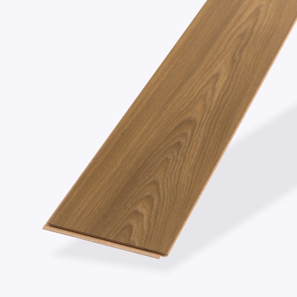 A single plank of Brown Toasted Oak flooring, featuring a light brown wood-look finish with a natural grain pattern, isolated on a white background.