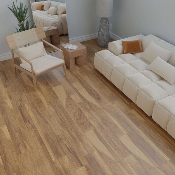 A modern living room featuring Johnson*: a cream-colored sofa with pillows, a light wood chair, tall gray lamp, plant, mirror, two small wooden tables, and wood flooring. The decor is minimal and neutral-toned.