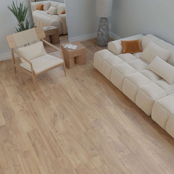 A modern living room featuring the Louise* cream sofa with orange and white pillows, light wood flooring, a wooden chair, floor lamp, plant, and a large mirror against a light gray wall.