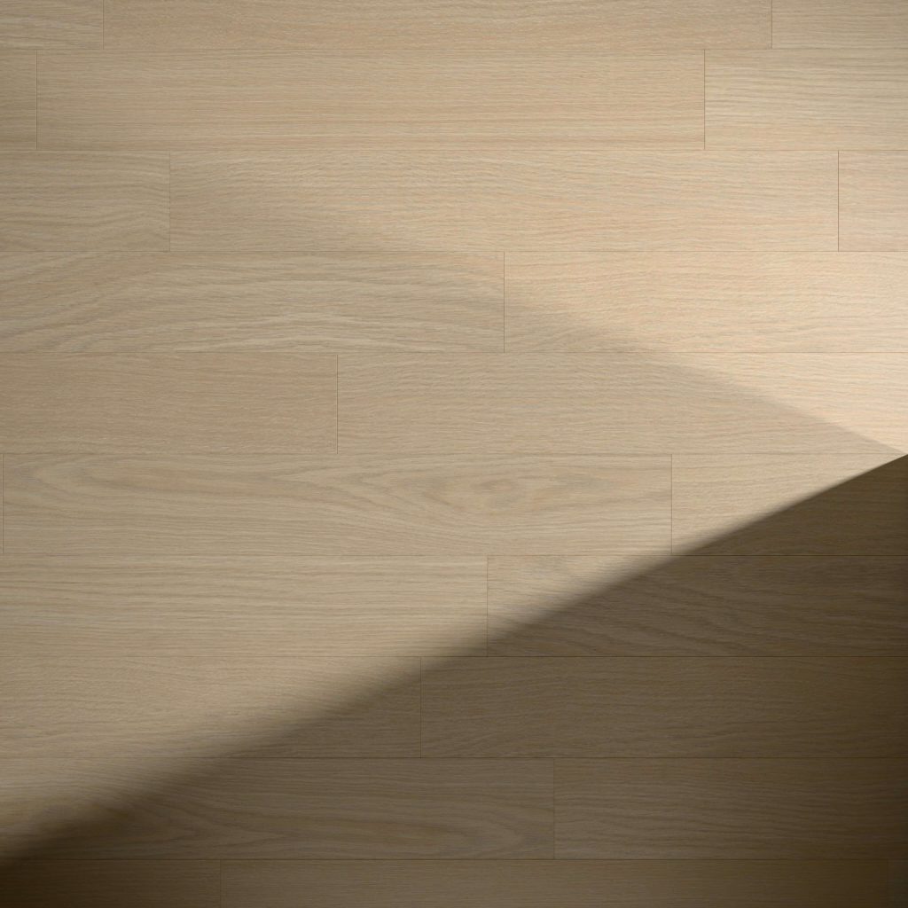 Agnes light wood flooring features visible grain and plank lines, with a soft shadow cast diagonally across the surface, forming a triangular dark area in the lower right corner.