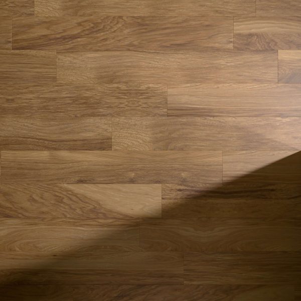 A Marmot* wooden floor featuring a natural brown grain pattern, partially covered by a diagonal shadow on the right side of the image.