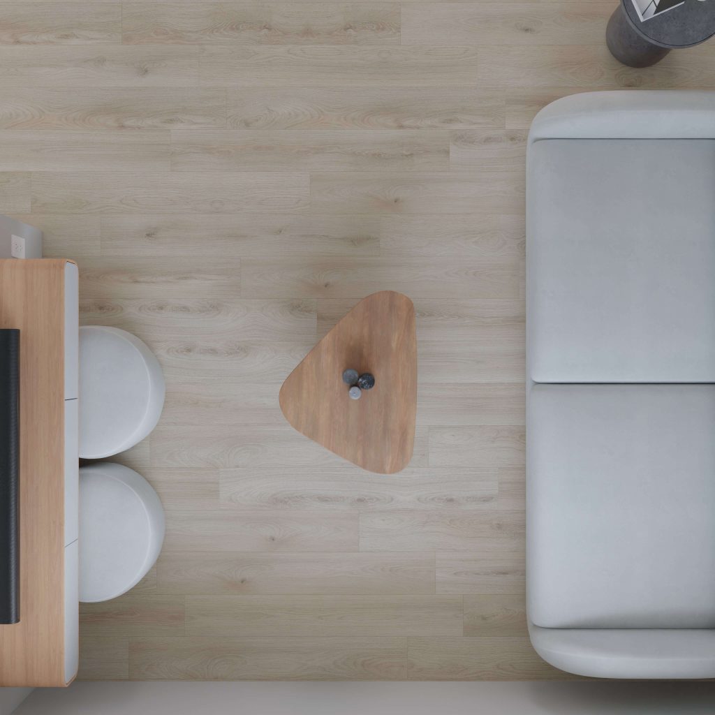 Minimalist living room seen from above, highlighting a light wood floor, gray sofa, Tekarra triangular wooden coffee table with two vases, TV stand, and two round white stools.