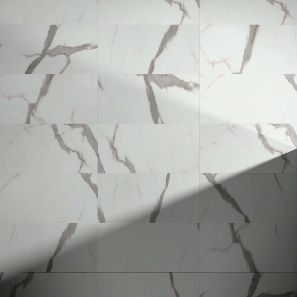 Calcatta* white marble tiles, featuring gray veining and a grid layout, have a diagonal shadow over the lower right section, highlighting the contrast between the lit and shaded areas.