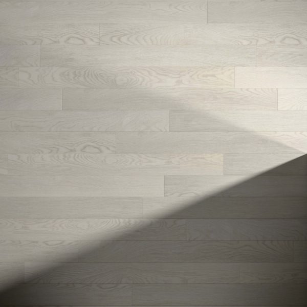 Wentworth* light wood flooring showcases visible grain patterns. A diagonal shadow falls over the lower right, highlighting the contrast between illuminated and shaded areas on the floor.