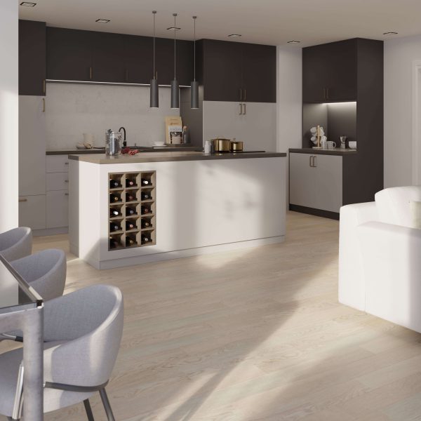 Modern kitchen featuring Hillston* dark upper cabinets, a spacious island with built-in wine rack, pendant lighting, light wood floors, and gray barstools. Natural sunlight pours in from a nearby window.
