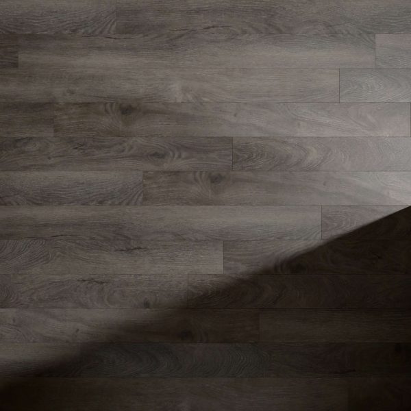 Valley Springs dark wood laminate flooring features a natural grain pattern with slight tone variations. Planks are laid horizontally, and a diagonal shadow falls across the lower right corner.