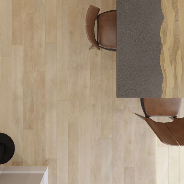 Top-down view of the Brook Falls light wood floor with two brown chairs and a gray wavy-edged table on the right. A small section of a white and black object appears in the bottom left.