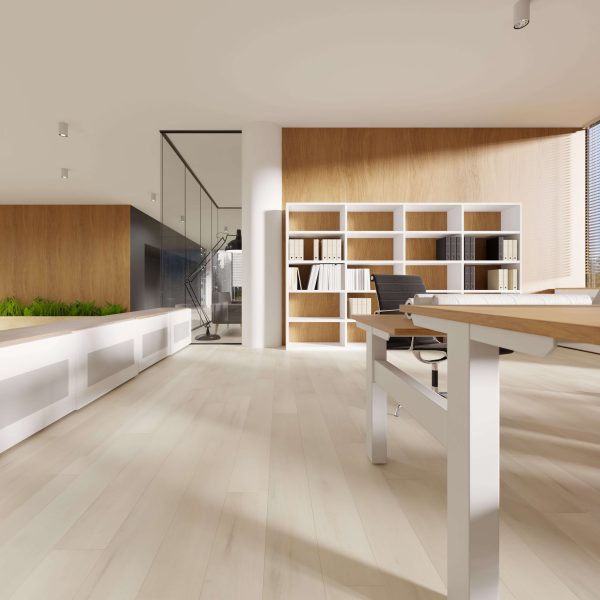 The Clermont features a modern office with light wood floors, white shelves of books, a black chair, wooden desk, and large windows for natural light. Glass walls and green plants add to the contemporary atmosphere.