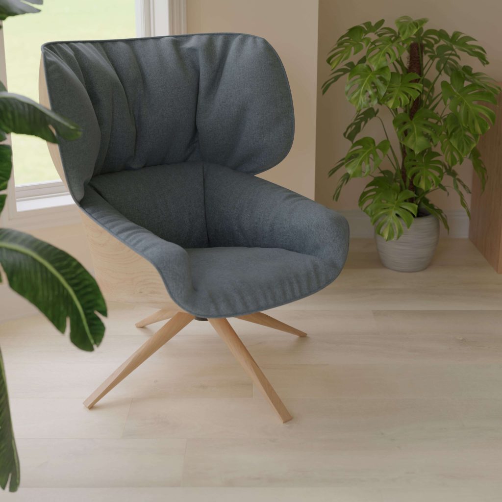 The Atherton* blue armchair with wooden legs is placed on a light wood floor beside potted green plants in a bright room with large windows.