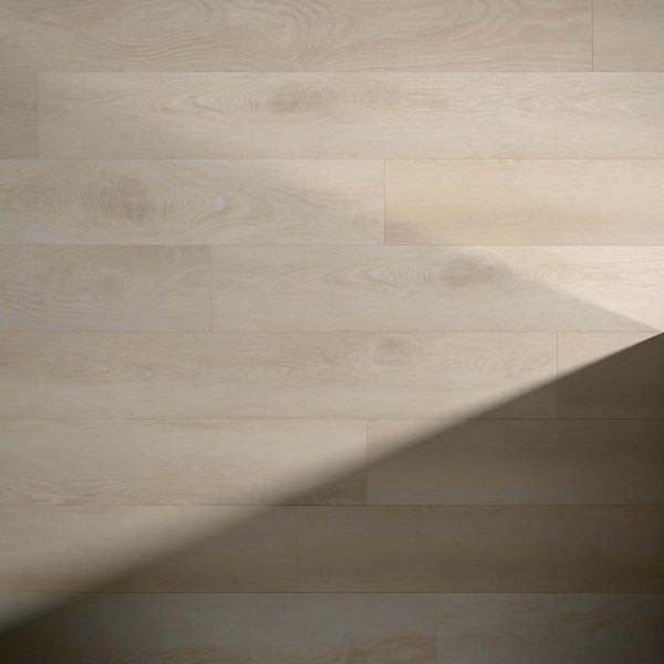 Dorrigo* light wooden floorboards feature subtle grain patterns; a diagonal shadow stretches across the surface, highlighting the contrast between sunlit and shaded areas.