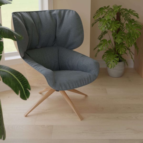 The Barossa*, a modern gray upholstered swivel chair with wooden legs, is placed on a light wood floor beside green potted plants by a window in a bright, cozy room.