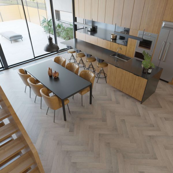 The Sandy Ridge kitchen and dining area features wood cabinetry, a long black island with five bar stools, a black dining table for eight, herringbone wood floors, large windows, and views of an outdoor patio through the glass.