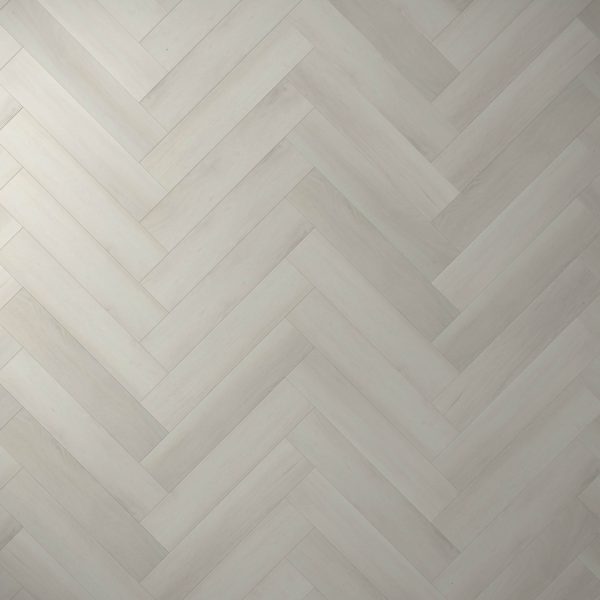 Glenbrook* features a light gray wooden floor in a herringbone pattern, with smooth, evenly finished planks laid diagonally to create a repeating V-shaped design.