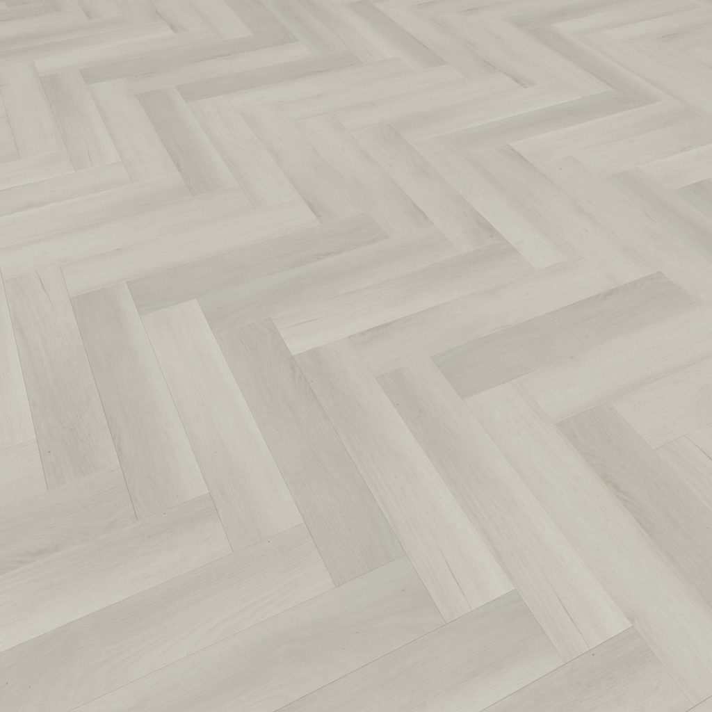 Glenbrook* is a light-colored wooden floor arranged in a herringbone pattern, showcasing alternating directions for a striking zigzag geometric design with a smooth, even finish.