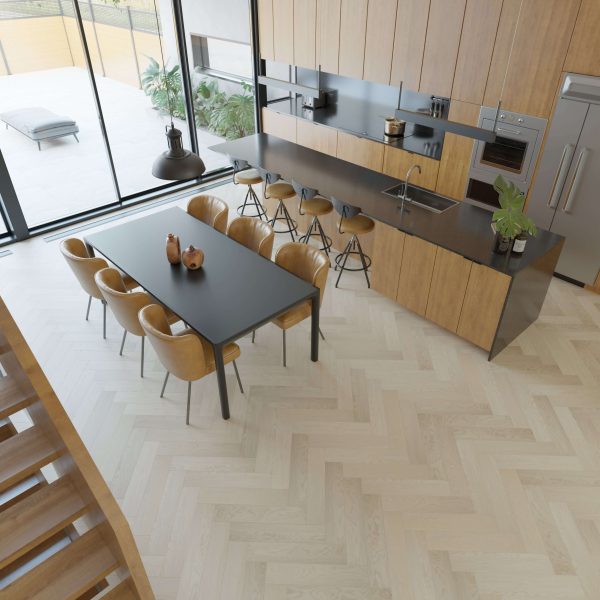 The Wentworth* features a modern kitchen and dining area with wood cabinetry, a black dining table for eight, tan chairs, island bar stools, large windows, and light wood herringbone flooring.