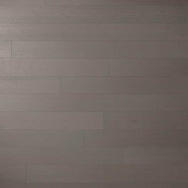 Silver Rock Oak* is a dark gray wooden floor with horizontal planks in a staggered pattern, featuring subtle wood grain and occasional knots. The matte finish and even color tone add to its modern appeal.