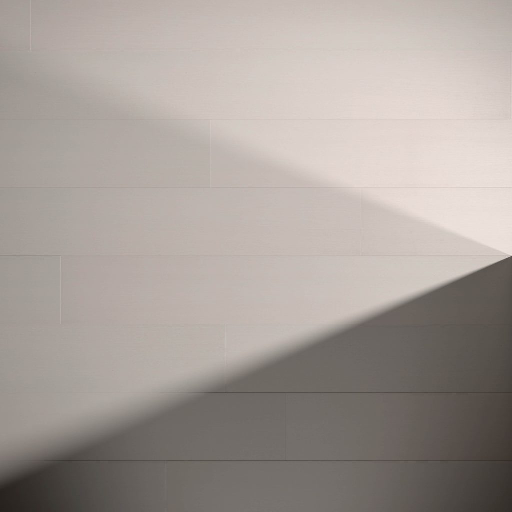 A plain light gray Dove Oak R&Q* wall with horizontal lines and a diagonal shadow from the lower right corner, forming a triangular shape on its surface.