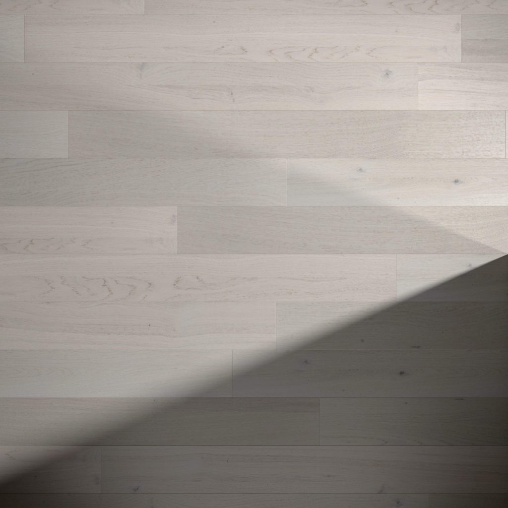 Crema Rustic Oak* features light-colored wooden floorboards with subtle grain patterns. A diagonal shadow crosses the lower right corner, adding contrast between the illuminated and shaded areas of the floor.