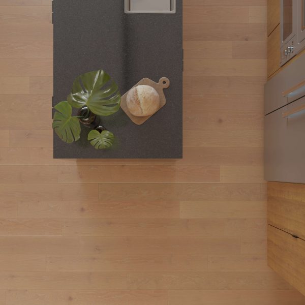 Overhead view of a kitchen island with a dark countertop, a potted plant, and bread on a wooden cutting board. Basin Rustic Oak* light wood flooring and part of a cabinet are visible.