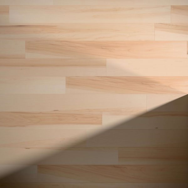Maple Natural* wooden floorboards feature a light color, with a diagonal shadow crossing the lower right corner and highlighting the contrast between bright and shaded areas.