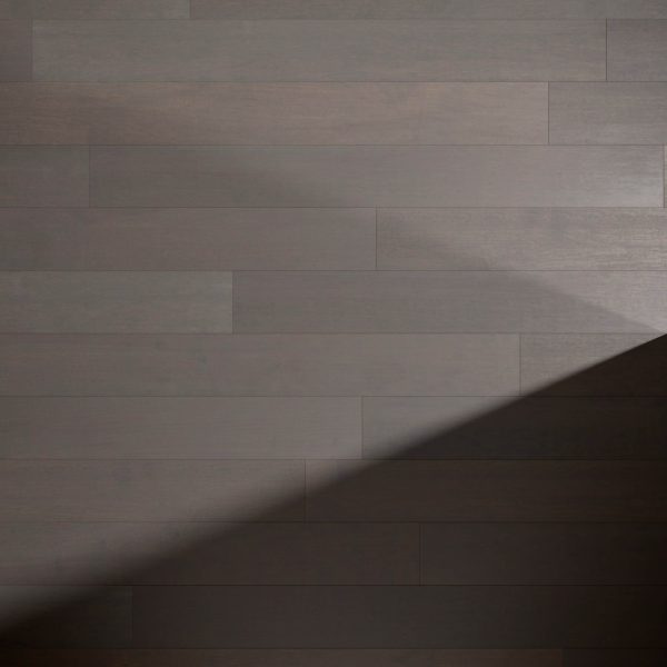 Maple Latte* wooden floorboards with a diagonal shadow in the lower right corner, highlighting the contrast between their illuminated and shaded sections.