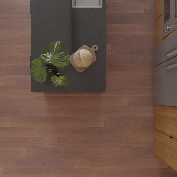 Overhead view of a kitchen island featuring the Harvest Walnut* countertop, a loaf of bread on a wooden board, and a green leafy plant, set against a wooden floor with surrounding wooden cabinetry.