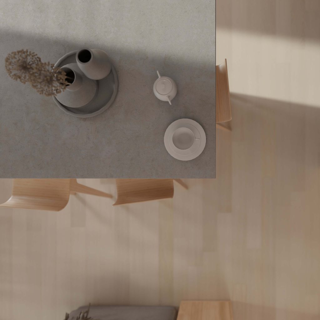 Minimalist table setting with Alabaster Oak* surface, round tray holding two vases with dried flowers, white teapot, empty cup and saucer, and light wooden chairs on a pale wood floor.