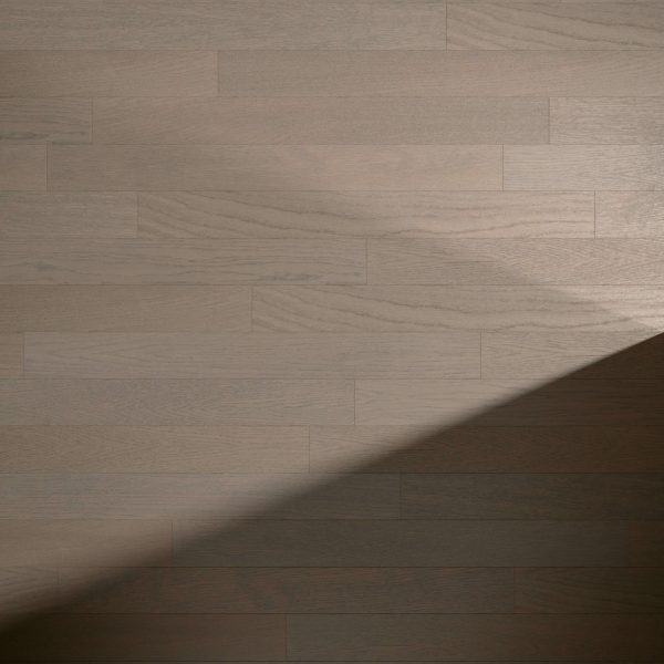 Cortland Oak* features light brown wooden planks with visible grain patterns arranged in a staggered layout. A diagonal shadow crosses the lower right corner, contrasting with the brighter upper area.