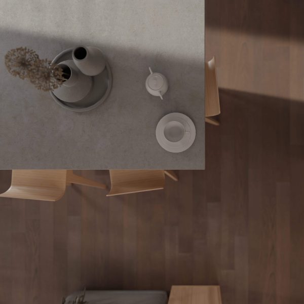 A minimalist table setting viewed from above, featuring the Bramble Oak* tabletop with two wooden chairs, a tray with vases and dried flowers, a teapot, and a cup and saucer atop a dark wooden floor.
