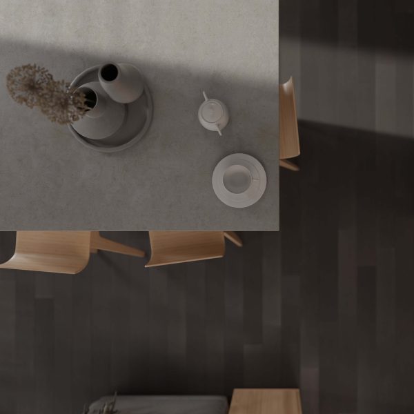 Minimalist overhead view of a light-colored table with a teapot, cup, saucer, and vase with dried flowers. Three light wooden chairs sit on a Cityscape Oak dark wood floor.