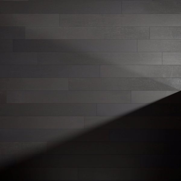 Cityscape Oak planks are arranged horizontally on a wall, with a diagonal shadow in the lower right corner, highlighting the contrast between light and dark areas.