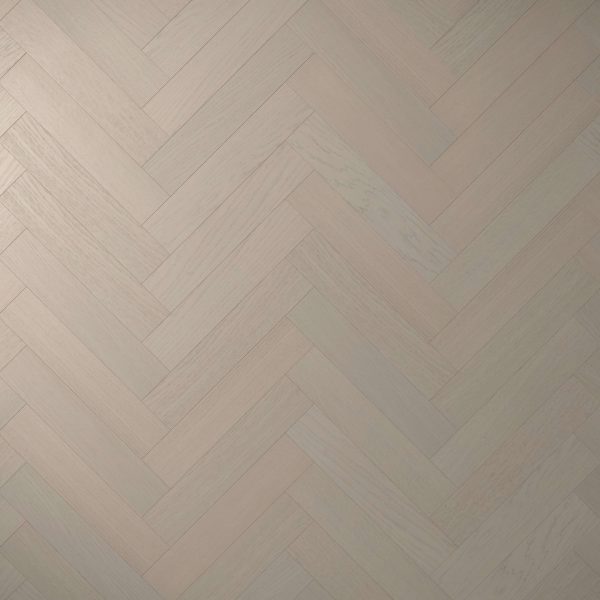 Everglade Oak* (Left) features a light-colored wooden floor in a herringbone pattern, showcasing subtle wood grain variations and shades for a soft, elegant geometric look.