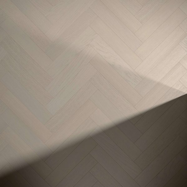 Everglade Oak* (Left) light wooden floor with a herringbone pattern, partly shaded by a diagonal shadow in the image corner.