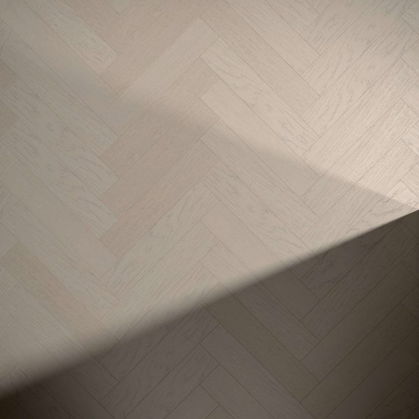 Everglade Oak* (Right) flooring in a light wooden herringbone pattern, with a diagonal shadow across the bottom right corner.