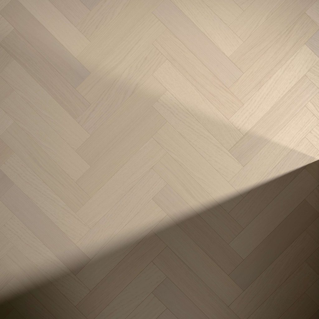 A large diagonal shadow partially covers a light-colored Coastal Oak* (Left) herringbone wood floor.