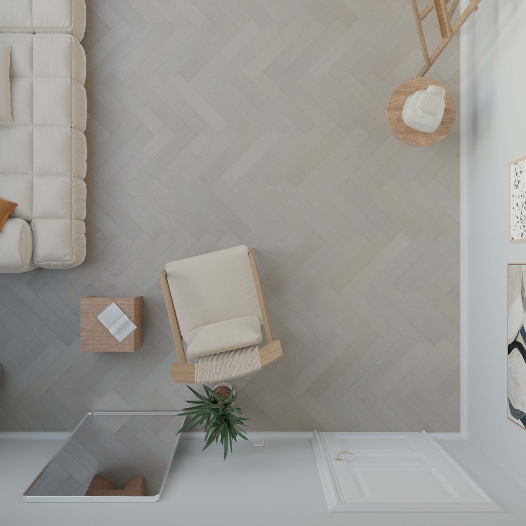 Top-down view of a minimal living room with a cream sofa, beige armchair, two tables, potted plant, mirror, wall art, and Castle Rock Oak* (Left) herringbone-patterned flooring.