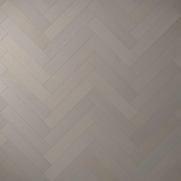 Castle Rock Oak* (Left) features a light gray wood floor in a herringbone pattern, with smooth rectangular planks laid diagonally in alternating directions and a subtle wood grain texture.