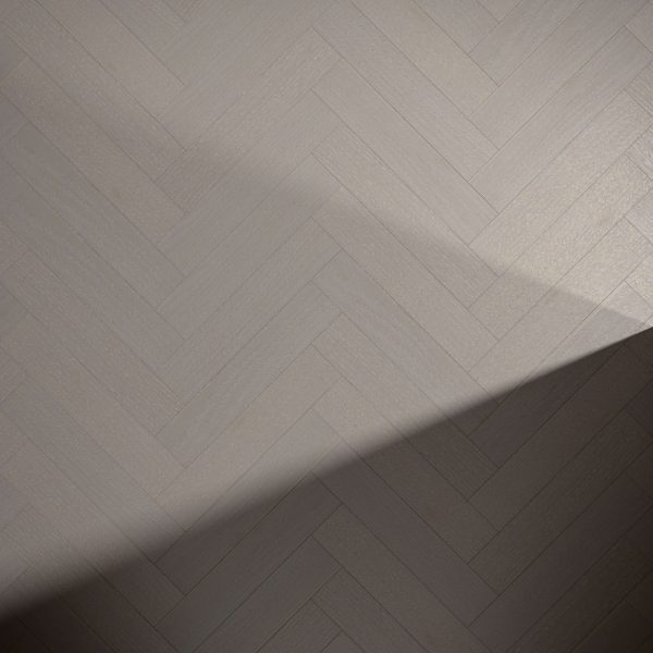 A light-colored Castle Rock Oak* (Right) floor features a herringbone pattern, with a diagonal shadow crossing part of its surface.