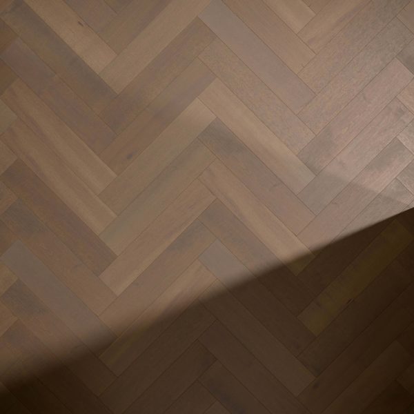 Maple Arabica* (Left) herringbone wood flooring in brown tones features a diagonal shadow across the lower right corner.
