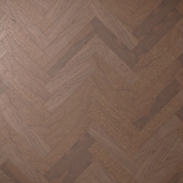 Close-up of Harvest Walnut* (Right) herringbone floor with medium brown planks, highlighting the wood's natural grain and texture. The zigzag pattern forms a visually striking geometric design.