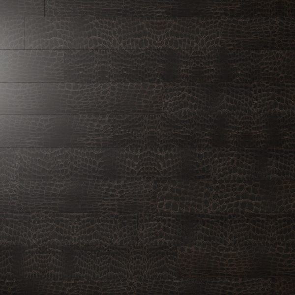 Modena Wine’s dark brown wooden flooring features a subtle, textured pattern reminiscent of alligator skin, with soft light highlighting its unique design in the upper left corner.