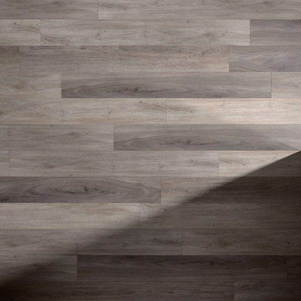 Tokyo Oak* features a light brown wooden floor with visible grain patterns and horizontally arranged planks. A diagonal shadow crosses the lower right corner, highlighting the contrast between lit and shaded areas.