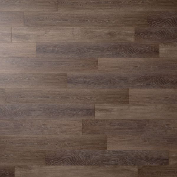 Sydney Oak* laminate flooring features a dark brown hue and realistic wood grain, laid in a staggered brick pattern. The smooth surface has subtle tonal and textural variations, offering the authentic look of natural wood.